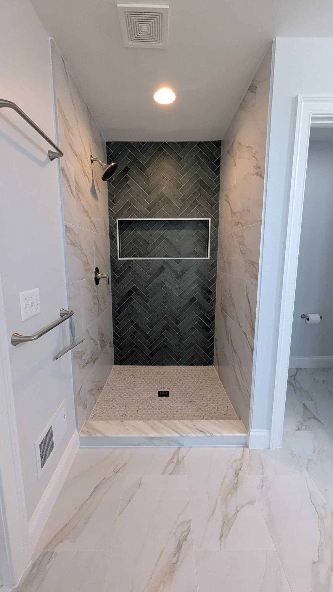Bathroom with a herringbone tile walk-in shower